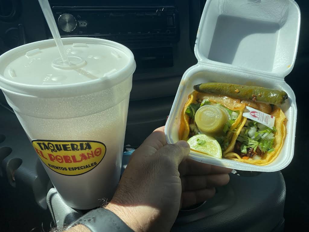 Taco meal with branded Taqueria El Poblano drink