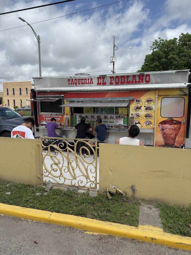 Daytime view of the Taqueria El Poblano food truck and outdoor seating